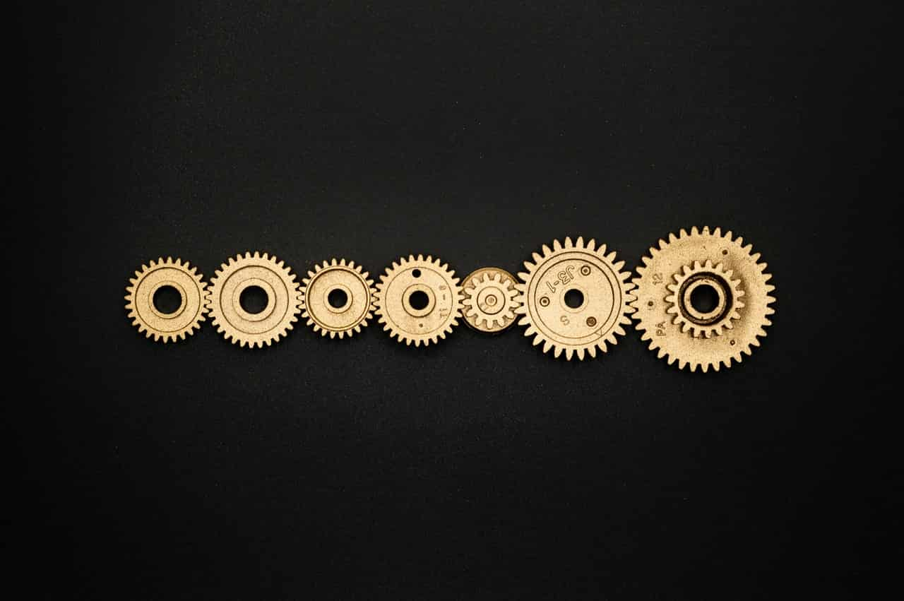 photo-of-golden-cogwheel-on-black-background-3785927 (1)