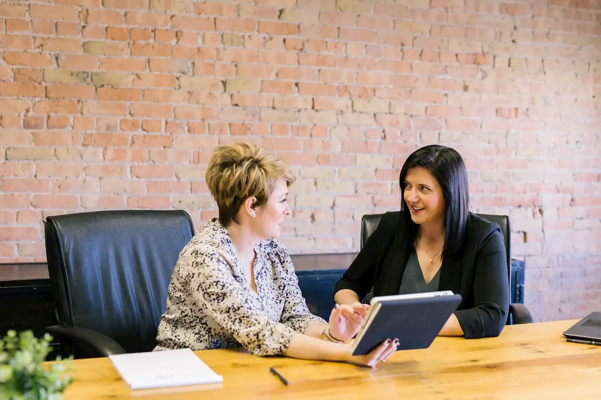 Photo of a female manager coaching her direct report on how to complete a project more productively 