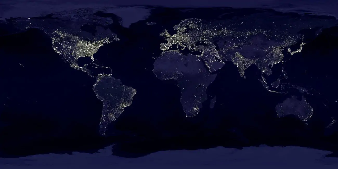 Black and dark blue map of the world with lights indicating how urban every location is. 